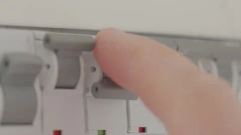 Hand switching circuit breaker in electrical distribution panel Stock Footage 331739767