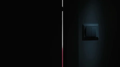 A Hand Switching On the Light in a Dark Room Stock Footage 82643732