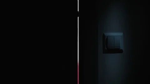A Hand Switching On the Light in a Dark Room Stock Footage 82644066