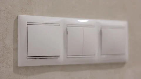 Hand Switching On Light On White Switch Panel 스톡 동영상 286981855