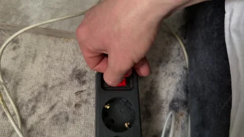 Hand switching power strip on and off close up, home electricity and safety Stock Footage 337120260