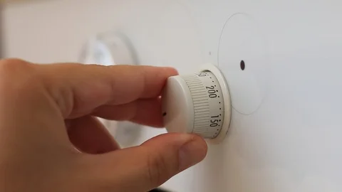 Hand switching temperature modes on the control of the oven Stock Footage 116784818