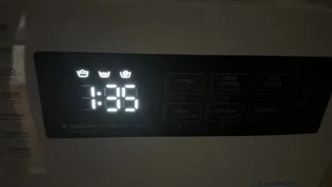 Hand switching washing machine modes on control panel, selecting laundry program 動画素材 337120119