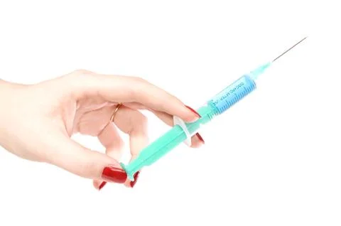Hand with a syringe Stock Photos