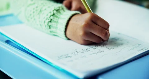 Hand, table and writing in book with pencil, diary entry and homework for Stock Footage 318790908