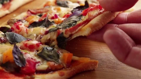 Hand take delicious pizza slice with stretching cheese vegetables basil sauce Stock Footage 152274694