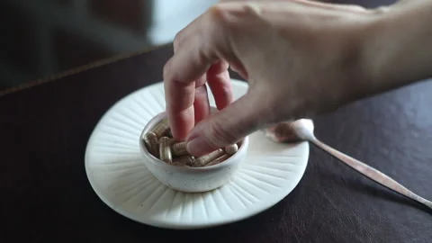 Hand take a pill from a full plate of medicines, capsules Video stock 170962037