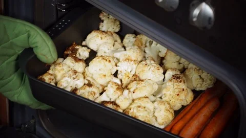 Hand take vegetables out of the oven 4K Stock Footage