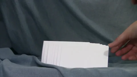 Hand takes 3 x 5 card away for presentation against a background Video stock 35533246