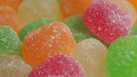 Hand takes and puts back marmalade colourful jelly Stock-Footage 152485748