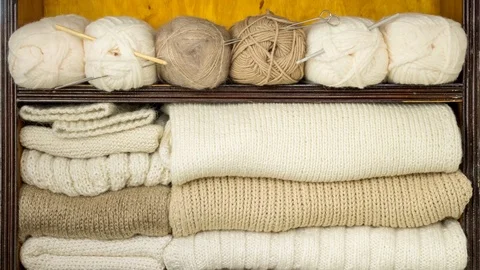 Hand takes the balls of wool, knitting needles, woolen fabrics from the shelves Stock Footage 85387160