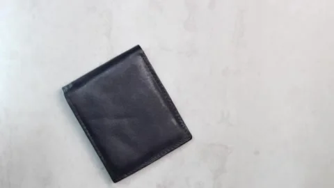 Hand takes black wallet on table Stock Footage 306239436