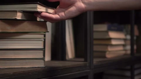 Hand takes a book from the shelf. close-up. Stock Footage 209308991
