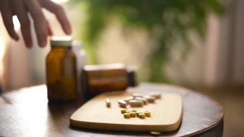 Hand takes bottle of vitamins. Alternative medicine herbal organic Stock Footage 314299768