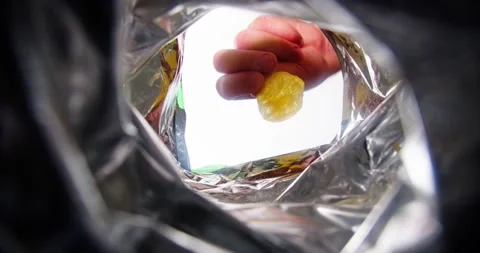 Hand takes chips out of the pack Stock Footage 237883583