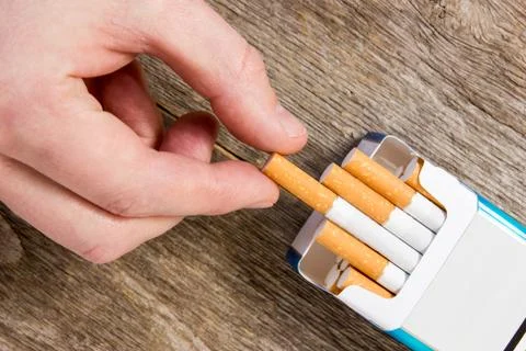Hand takes a cigarette Stock Photos