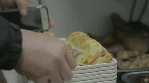 Hand Takes Cooked Sandwich from Stack of Plates in Beijing Street Food Kitchen Stock Footage 345856317