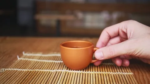 Hand takes cup of coffee in cafe 库存影片 150402210