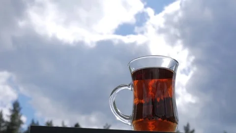 Hand takes a Cup of tea on a background of clouds. Stock Footage 83109024