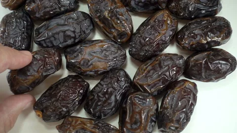Hand takes a date from a pile of dates fruit Video stock 135920430