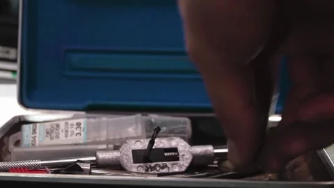 Hand takes the drill bit Stock Footage 171884655