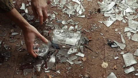 Hand takes from the floor a bottle of vodka and a glass Stock Footage 80720558