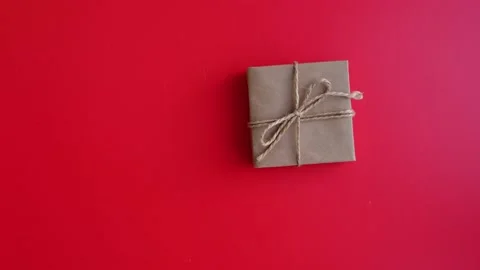 Hand takes a gift, layout with space for text, flat lay on a red background Stock Footage 168676550