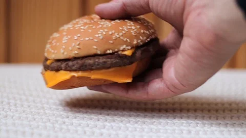 Hand takes a hamburger from the table Stock Footage 106349281
