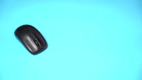 The Hand takes the Mouse and Clicks. Blue Background Stock Footage 150454490