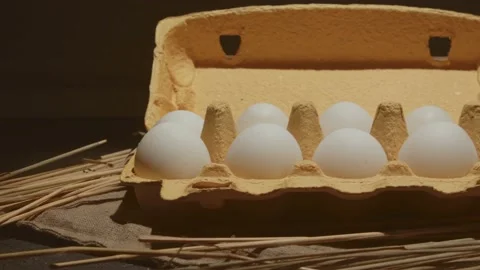 Hand takes one from 3 eggs white packed in carton 4K video 動画素材 130884120