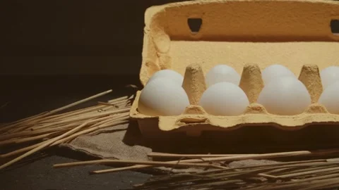 Hand takes one from two eggs white packed in carton 4K video Stock Footage 130884110