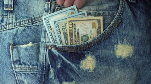 Hand takes out dollar bills from jeans pocket in 4K Stock Footage 137775587