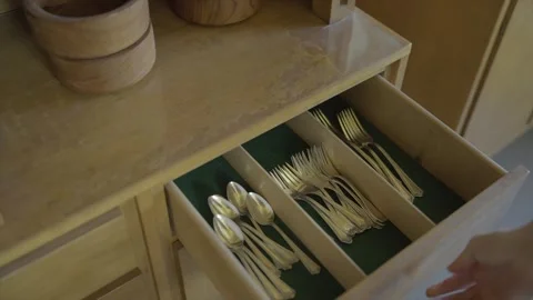 Hand takes out fancy silverware from hutch Stock Footage 313703122