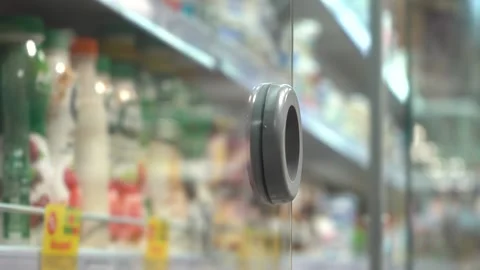 A hand takes a plastic bottle from a refrigerated shelf in a store. Stock Footage 142953954