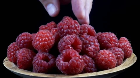 Hand takes raspberry from a plate Stock Footage 138249618