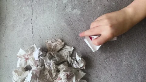 A Hand takes a receipt from a store, crushes it and throws it Stock Footage