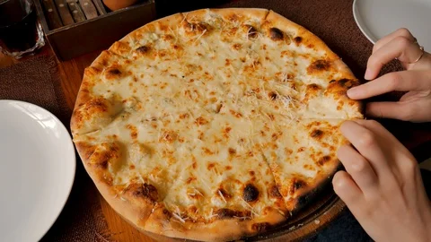 Hand takes a slice of gray pizza at a restaurant. Female hand. Four cheeses Video stock 123649152
