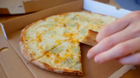 The hand takes a slice of pizza from the box Stock Footage 243187437
