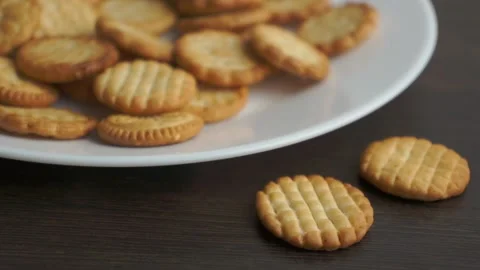 Hand takes small round cookie from the plate Stock-Footage 152829845