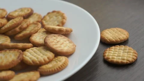 Hand takes small round cookie from the plate Stock-Footage 152829847