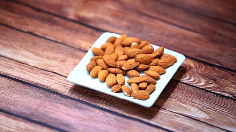 Hand takes some almonds nuts on wooden table Stock-Footage 34951147