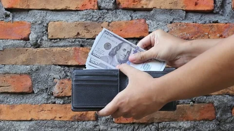 Hand takes some dollar bills from wallet Stock Footage 323251536