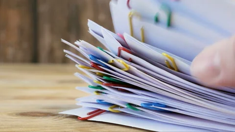 Hand takes stack of documents with binder clips wooden table, closeup Stock Footage 149046315