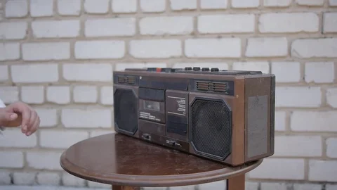 Hand takes from the table the retro dusty tape recorder. Stock Footage 69777813