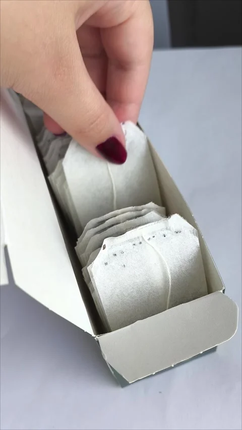 A hand takes a tea bag from a package. Stock Footage 311975038
