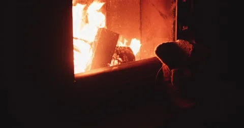 Hand takes Warm Winter Boots from Shelf near Fireplace. 4K SLOW MOTION 120 fps Stock Footage 67217526