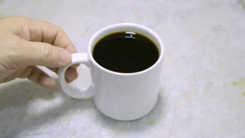 HAND TAKES WHITE CUP WITH COFFEE AND REMOVES Stock Footage 150337497
