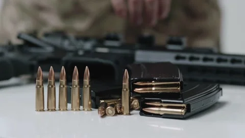 Hand taking ammo, bullets 762 caliber fo... | Stock Video | Pond5