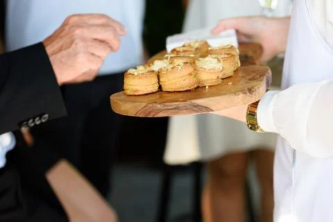 Hand taking appetizer Stock Photos