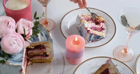 Hand taking a bite of modern wedding sponge cake served with flowers. Stock Footage 132510568